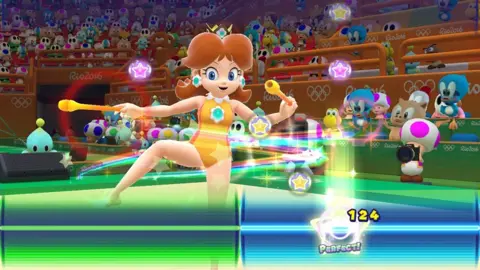 Nintendo A screenshot shows Princess Daisy wearing a yellow leotard and twizzling two batons as musical button prompts scroll down the screen. A line at the bottom denotes the point at which players must press the button, keeping the rhythm of the tune.