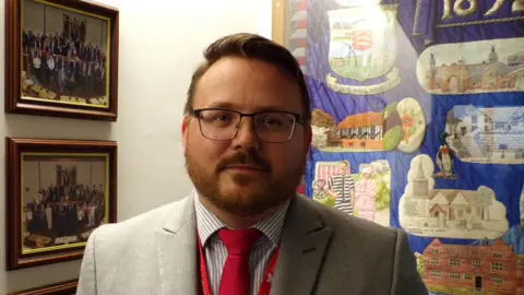 Daniel Cowan standing outside Southend's council chamber