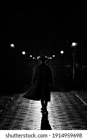 dark silhouette of a man in a coat and hat in the rain on a night street in the city in the style of Noir