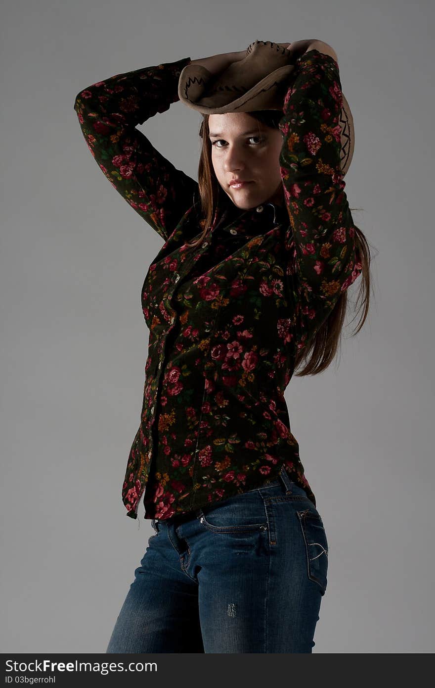 Attractive cowgirl portrait on white background