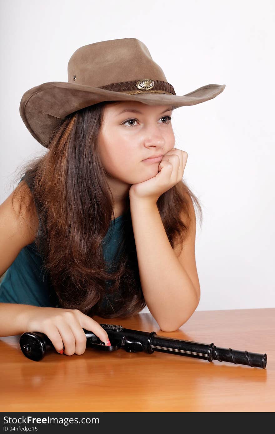 Cowgirl a hat with a gun