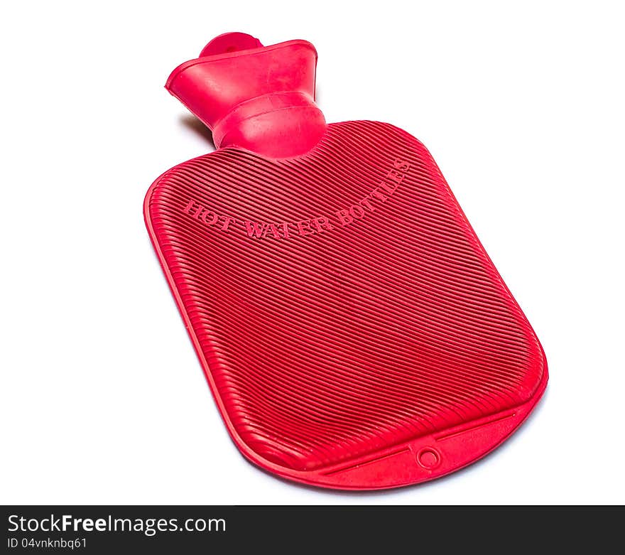 A red hot water bottle against a white background. A red hot water bottle against a white background