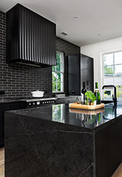 Serenbe House Dark and Dramatic Kitchen Island with Quartz Countertop