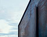 A tough, rusted steel exterior holds up against the elements of a construction site.