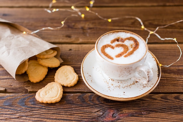 Foto grátis alto ângulo de xícara de café e biscoitos em forma de coração