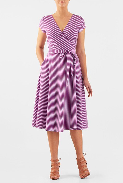 A surplice bodice lends feminine appeal to our stripe cotton jersey knit dress while attached sash ties and a seamed waist release the flared skirt.