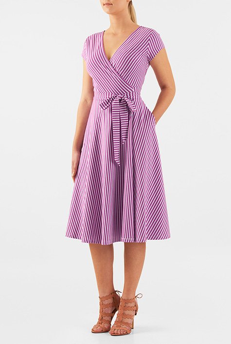 A surplice bodice lends feminine appeal to our stripe cotton jersey knit dress while attached sash ties and a seamed waist release the flared skirt.