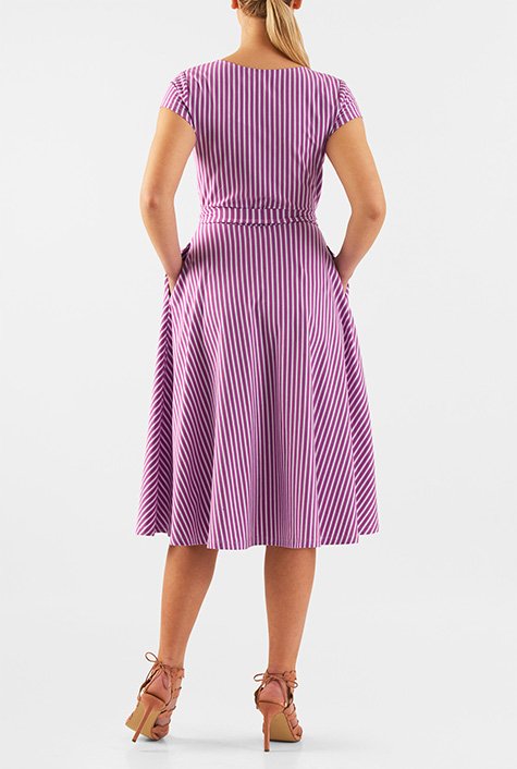 A surplice bodice lends feminine appeal to our stripe cotton jersey knit dress while attached sash ties and a seamed waist release the flared skirt.