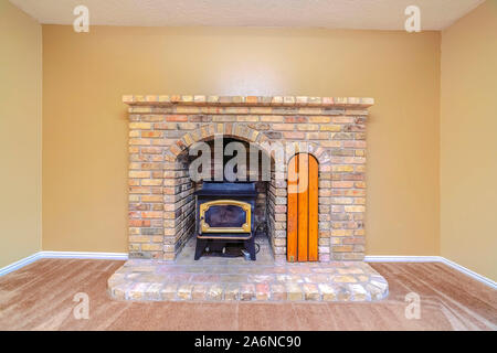 Brick fireplace with insert burner or furnace Stock Photo