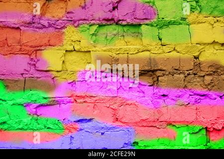 Multi-colored brick wall close-up. Bright fun background in the style of graffiti. Stock Photo