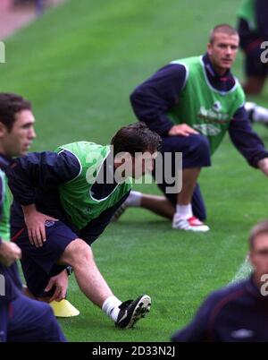 England's Robbie Fowler and David Beckham (top) stretching during training at Old Trafford, Manchester. England play Greece in the final game of the World Cup group nine qualifier. Stock Photo