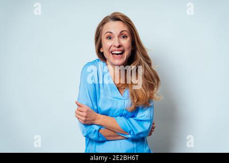 Cinematic portrait of a middle age beautiful woman posing on a white background Stock Photo