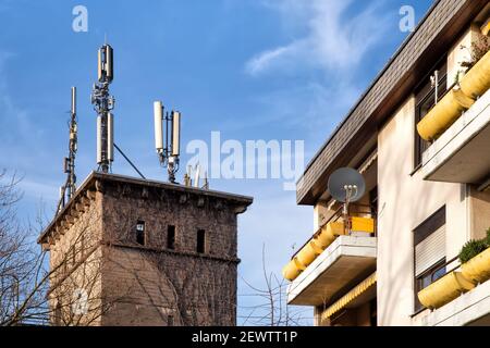 Antennas and transmitters on roof. Technology on the top of a building (5G, 4G) .Mobile phone antennas on a roof.Telecommunication TV antennas.Communi Stock Photo