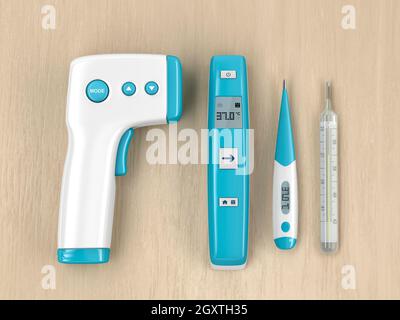 Different types of medical thermometers on wood table, top view Stock Photo