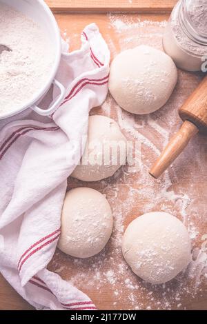 Yeast dough for making braided cakes, pies, pizza and rolls with rolling pin. Preparing leavened dough Stock Photo