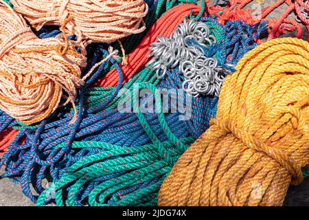 Ropes in red, green, yellow and blue colors for sale at livestock market in Cuenca, Ecuador. Stock Photo