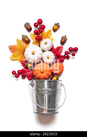 Autumn bouquet of acorns, berries, maple leaves, pumpkins in bucket cones isolated on white background Flat lay Top view Floral holiday card Hello Sep Stock Photo