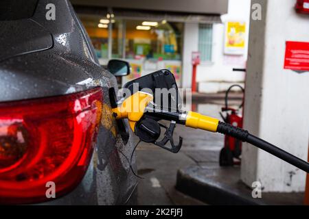 Pumping gasoline fuel in car at gas station. Refueling automobile with gasoline or diesel with a fuel dispenser. Stock Photo