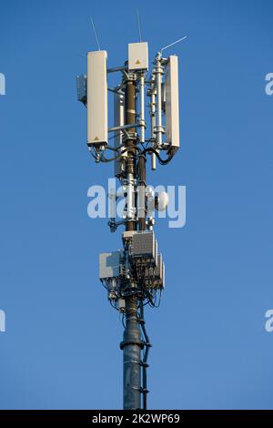 close-up of an antenna mast for mobile radio communications in front of blue sky Stock Photo