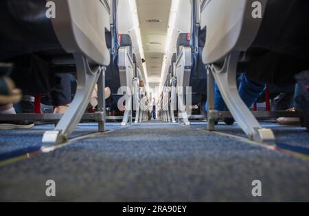 Normal class passenger jet airliner corridor. Ground view Stock Photo