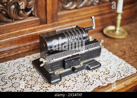 Old mechanical manual counting machine for arithmetical calculations. Stock Photo