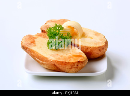 Butter curls melting on a baked potato Stock Photo