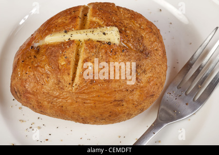 Baked potato with butter and black pepper Stock Photo