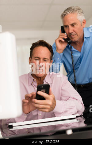 Caucasian businessmen working at desk Stock Photo