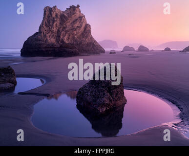 Low tide pools and seastacks reflecting sunrise. Bandon Beach. Oregon Stock Photo