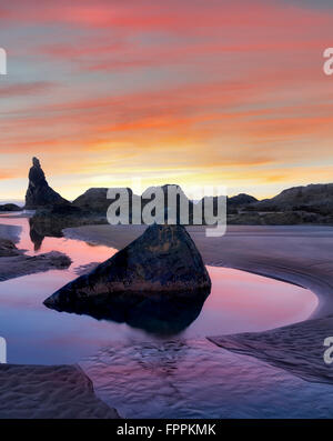 Low tide pools and seastacks reflecting sunrise. Bandon Beach. Oregon Stock Photo