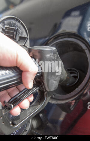 Man pumping gasoline fuel in car at gas station Stock Photo