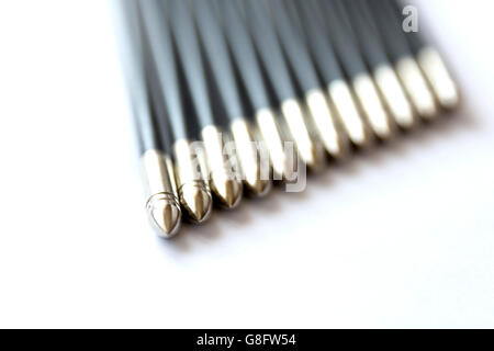 The spikes of a dozen (12) black arrows isolated on a white background. Stock Photo