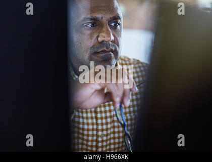 Serious focused businessman working at computer Stock Photo