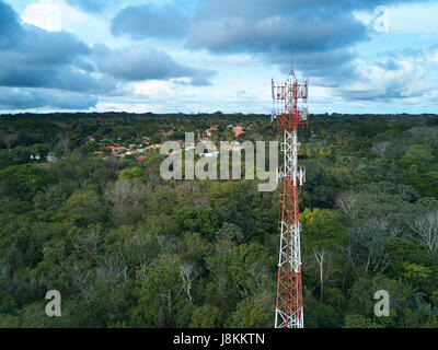 Mobile tower antenna aerial view on small town background Stock Photo