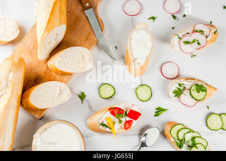 Healthy food. Spring, summer snacks. Sandwiches toast with homemade cream cheese and fresh vegetables - radish, cucumber, tomatoes, onion, pepper. On  Stock Photo