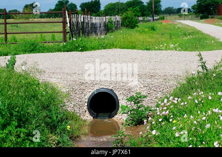 Drainage pipe: New culvert under small country side gravel road Stock Photo