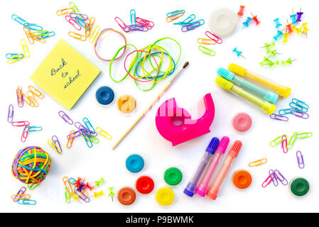 Back to shool written on sticky notes among  colorful school supplies  isolated on white background. Stock Photo