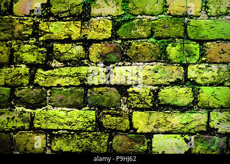 Bright colorful multicolored painted brick stone wall. Brick wall painted in bright colors Stock Photo