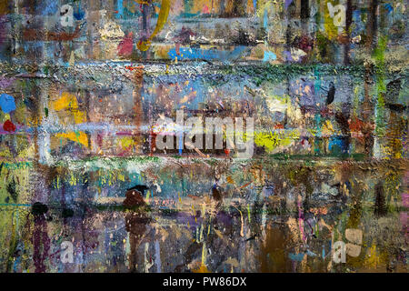 Creative coloured brick wall painted brightly. An abstract background wall covered with different colours. Colorful wall painted with oils. Art workro Stock Photo