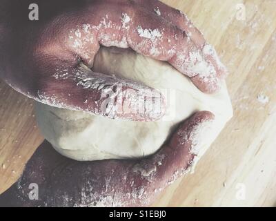 Male hands Kneading leavened dough Stock Photo