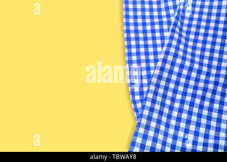 Blue checkered napkin on a yellow background. Stock Photo