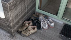 Pile of shoes by doorway