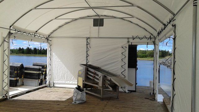 The inside of a tent with a view of a lake