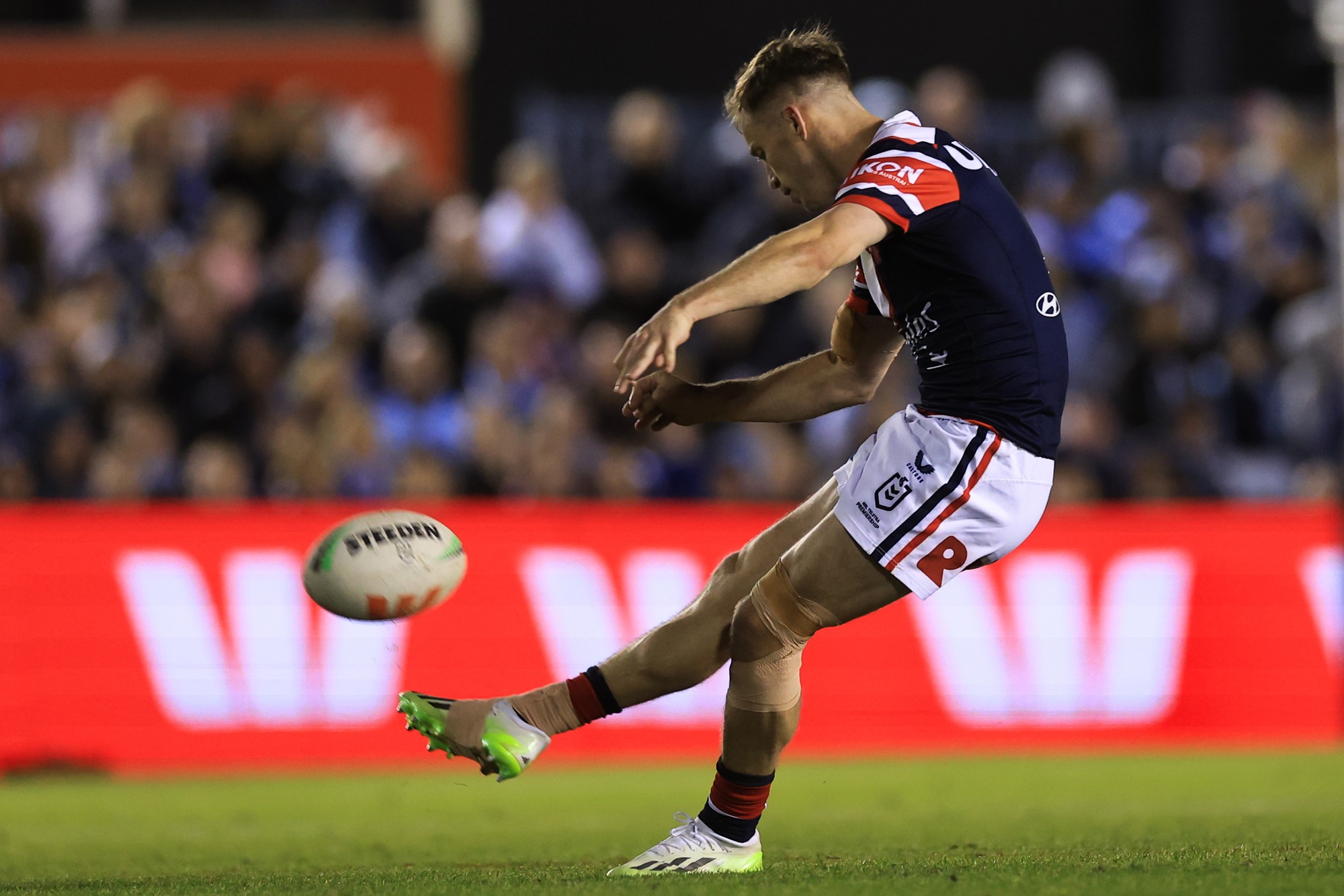 Sam Walker kicks a ball.