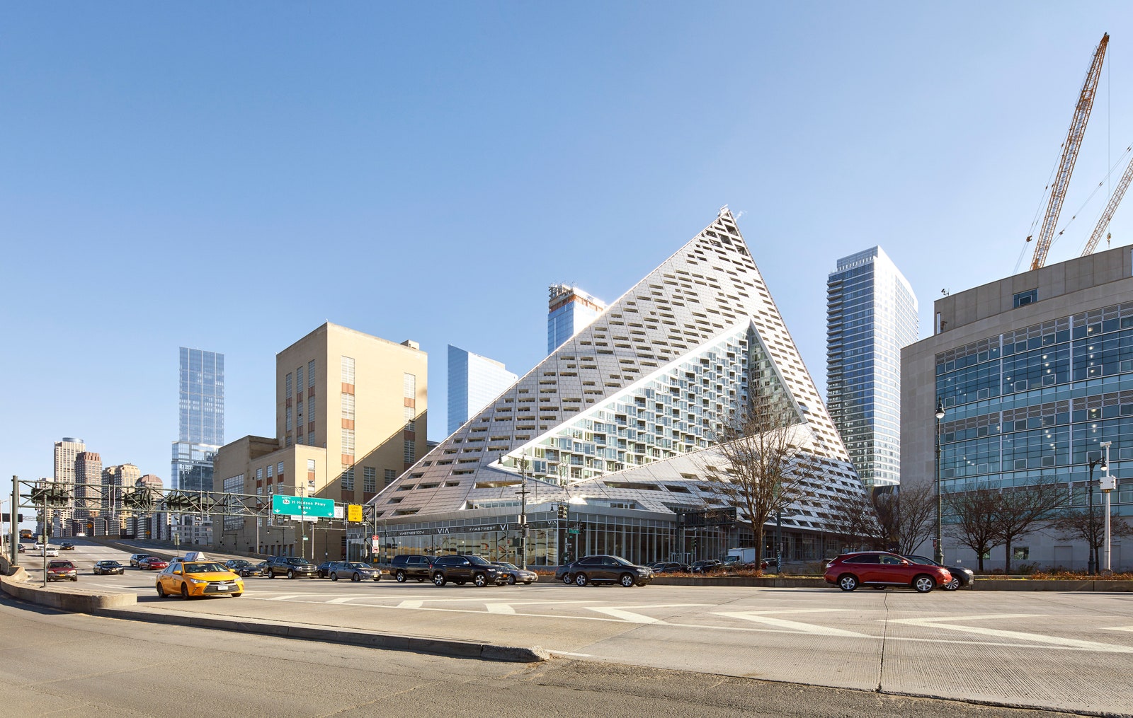 a building on a highway that is shaped like a triangle