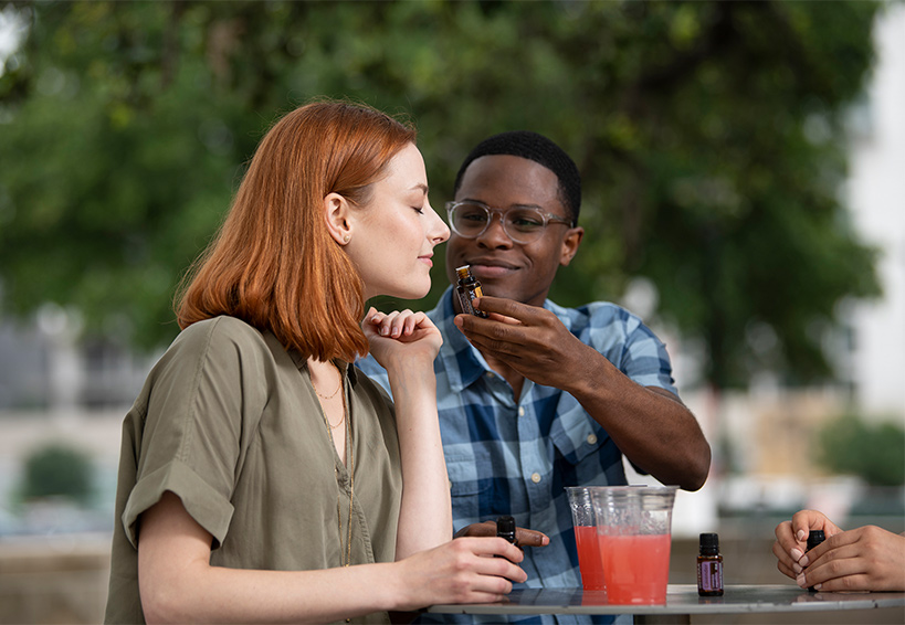 Woman smelling doTERRA essential oils.