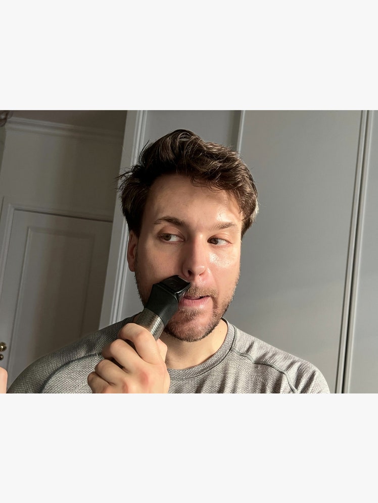 Person using Philips 9000 beard trimmer