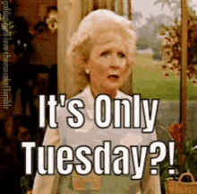 a woman says it 's only tuesday while standing in front of a door