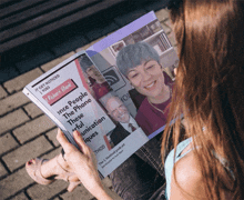 a woman is holding a magazine that says " it get noticed "