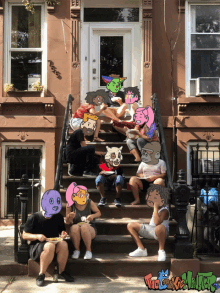 a group of people are sitting on the steps of a building with cartoon faces on their faces